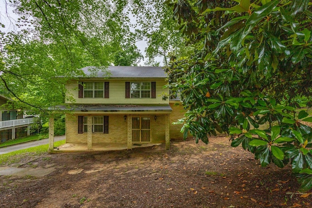 4510 Ravenwood Dr E, Chattanooga, TN 37415 - view of front of house with brick siding, a patio, and a shingled roof