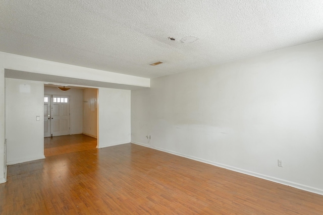 4510 Ravenwood Dr E, Chattanooga, TN 37415 - empty room featuring a textured ceiling, light wood-type flooring, and baseboards