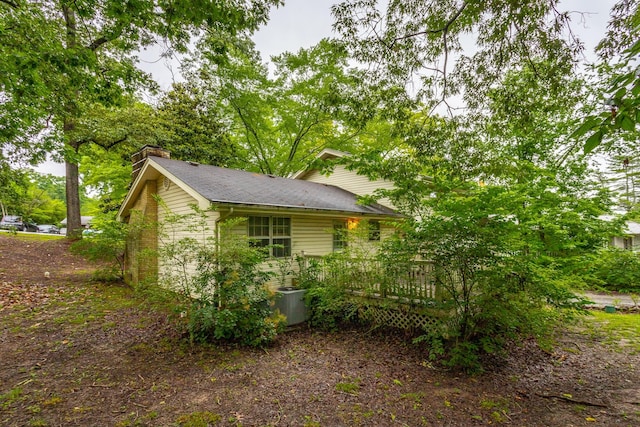 4510 Ravenwood Dr E, Chattanooga, TN 37415 - view of side of property with a deck, a chimney, central AC, and a shingled roof