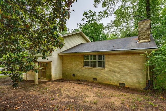 4510 Ravenwood Dr E, Chattanooga, TN 37415 - view of home's exterior featuring crawl space, brick siding, a chimney, and roof with shingles