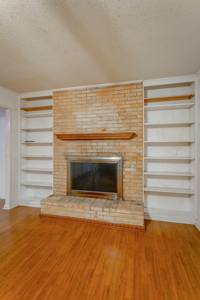 4510 Ravenwood Dr E, Chattanooga, TN 37415 - detailed view of a textured ceiling, a brick fireplace, built in shelves, wood finished floors, and crown molding