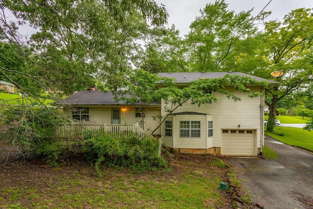 4510 Ravenwood Dr E, Chattanooga, TN 37415 - tri-level home featuring asphalt driveway, an attached garage, and a wooden deck