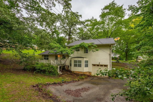 4510 Ravenwood Dr E, Chattanooga, TN 37415 - back of property featuring asphalt driveway, an attached garage, a porch, and stairway