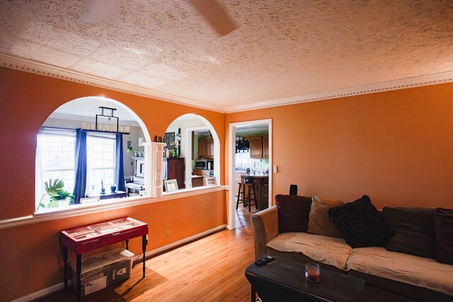 2014 Saddlebrook Dr, Murfreesboro, TN 37129 - living room with a textured ceiling, wood finished floors, arched walkways, and ornamental molding