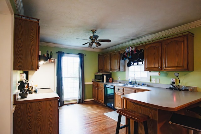 2014 Saddlebrook Dr, Murfreesboro, TN 37129 - kitchen featuring black dishwasher, stainless steel microwave, plenty of natural light, a breakfast bar, and ornamental molding