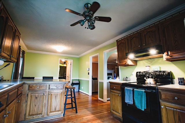 2014 Saddlebrook Dr, Murfreesboro, TN 37129 - kitchen featuring black range with electric stovetop, under cabinet range hood, a ceiling fan, arched walkways, and a kitchen breakfast bar