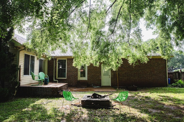 2014 Saddlebrook Dr, Murfreesboro, TN 37129 - rear view of house featuring a fire pit, brick siding, a deck, and a shingled roof