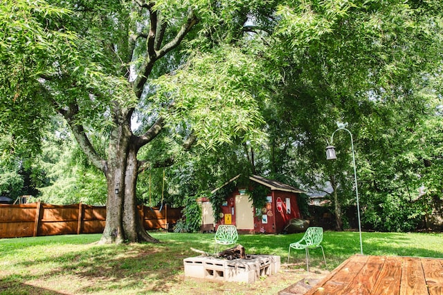 2014 Saddlebrook Dr, Murfreesboro, TN 37129 - fenced backyard featuring an outdoor fire pit, a wooden deck, and a storage unit