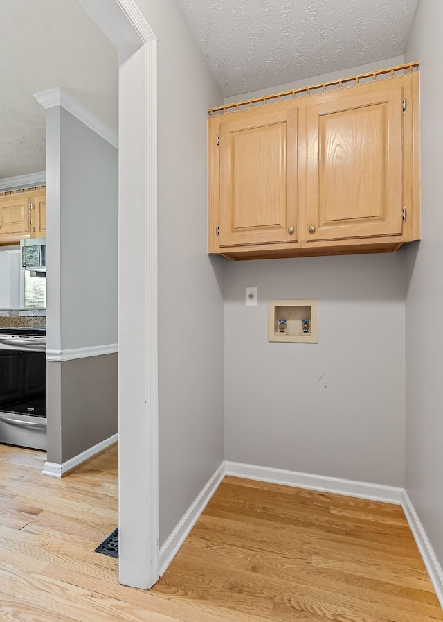829 Navajo Trl, Mcminnville, TN 37110 - laundry room with hookup for a washing machine, light wood-style flooring, hookup for an electric dryer, and baseboards