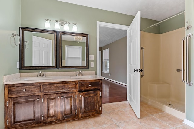 829 Navajo Trl, Mcminnville, TN 37110 - full bathroom featuring double vanity, a shower, a textured ceiling, tile patterned floors, and baseboards