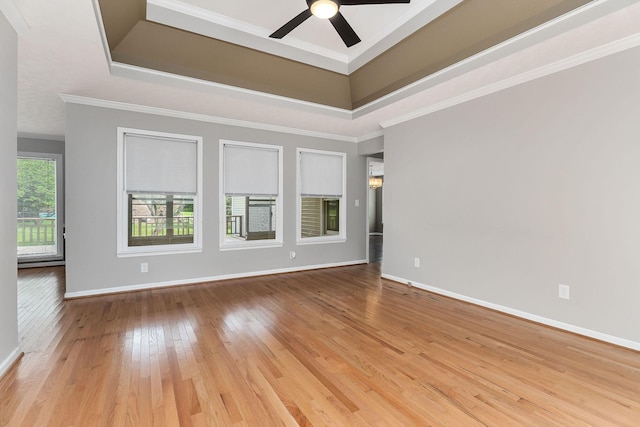 829 Navajo Trl, Mcminnville, TN 37110 - empty room with a raised ceiling, wood-type flooring, a ceiling fan, baseboards, and crown molding