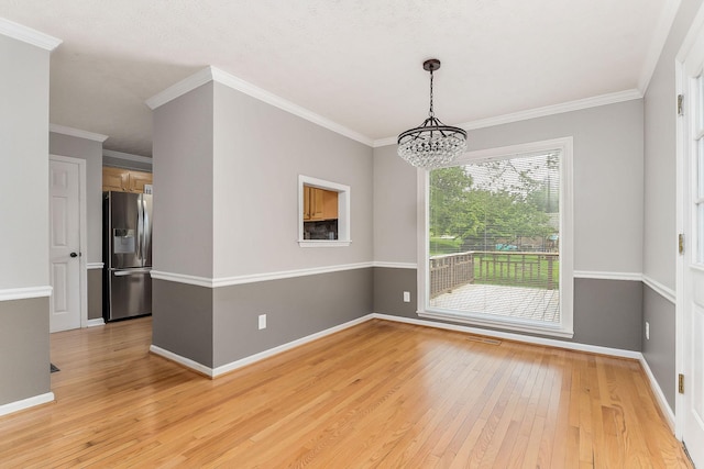 829 Navajo Trl, Mcminnville, TN 37110 - empty room with light wood finished floors, a chandelier, baseboards, and crown molding