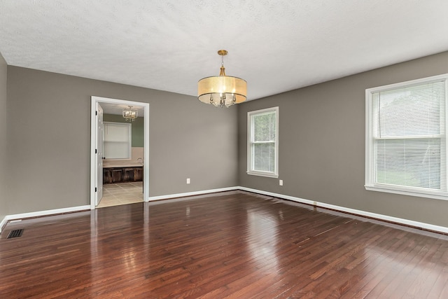829 Navajo Trl, Mcminnville, TN 37110 - spare room with a chandelier, hardwood / wood-style floors, and baseboards