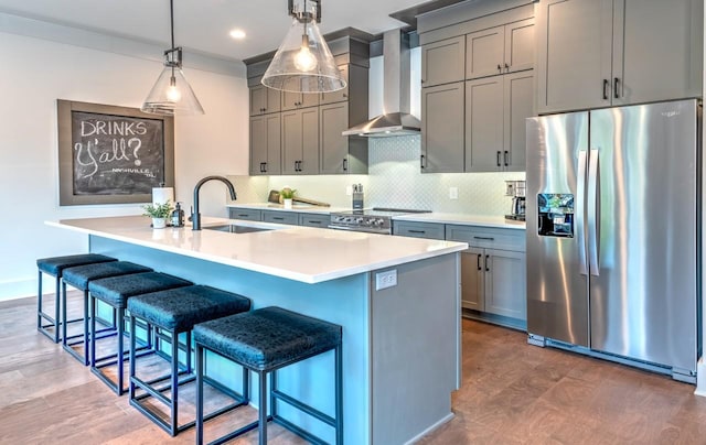 1106 Greenwood Ave, Nashville, TN 37206 - kitchen with stainless steel appliances, wall chimney exhaust hood, a sink, backsplash, and an island with sink