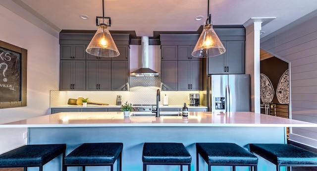 1106 Greenwood Ave, Nashville, TN 37206 - kitchen with stainless steel fridge, wall chimney range hood, light countertops, and a sink