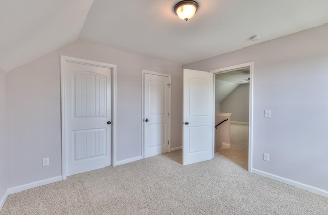 5502 Reflection Rd, Smyrna, TN 37167 - unfurnished bedroom featuring carpet, lofted ceiling, multiple closets, and baseboards