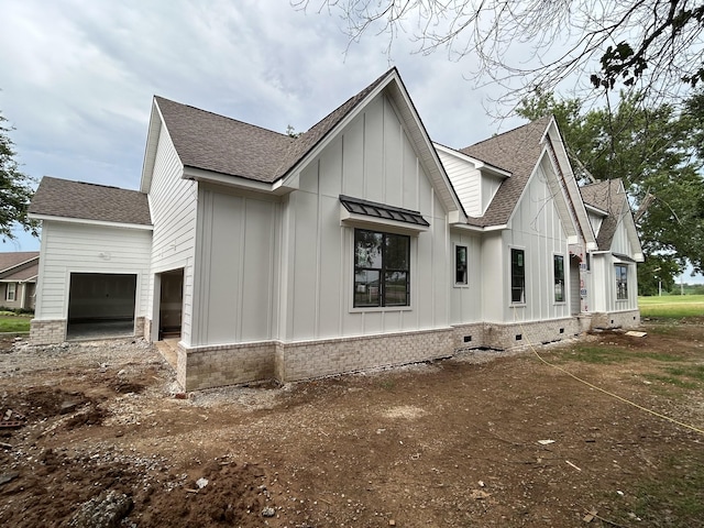 112 Stoneybrook Rd N, Columbia, TN 38401 - view of side of property featuring board and batten siding, a shingled roof, driveway, brick siding, and crawl space
