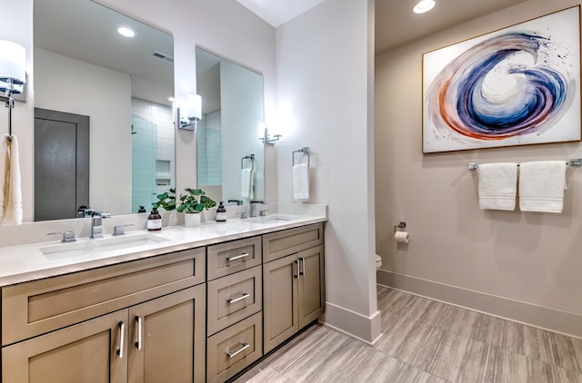 1108 Greenwood Ave, Nashville, TN 37206 - bathroom featuring double vanity, baseboards, a tile shower, toilet, and recessed lighting