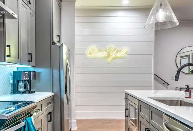 1108 Greenwood Ave, Nashville, TN 37206 - kitchen featuring stainless steel appliances, a sink, gray cabinets, light wood finished floors, and light countertops