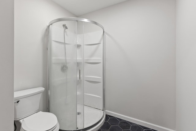 176 S Palmers Chapel Rd, White House, TN 37188 - bathroom with a shower stall, tile patterned floors, toilet, and baseboards
