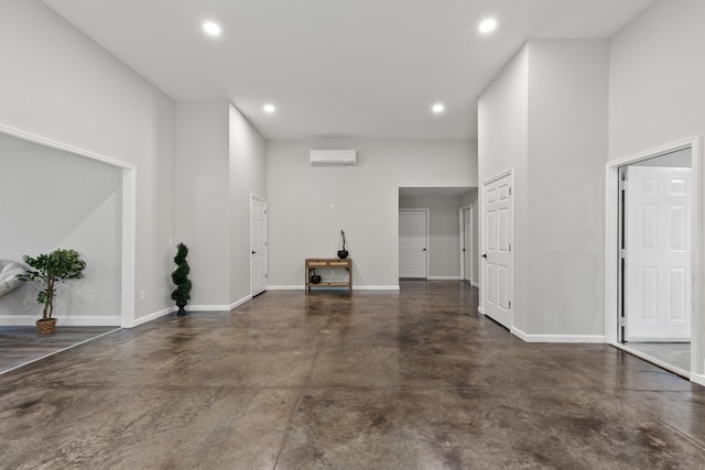 176 S Palmers Chapel Rd, White House, TN 37188 - unfurnished living room featuring finished concrete floors, recessed lighting, baseboards, and a wall mounted AC