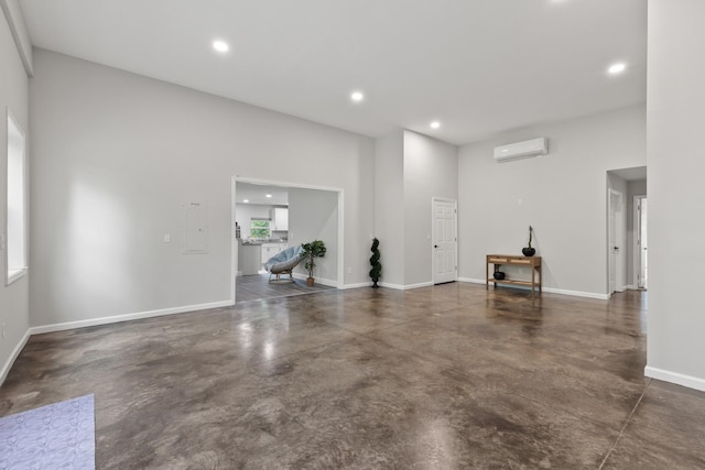 176 S Palmers Chapel Rd, White House, TN 37188 - unfurnished living room with concrete flooring, recessed lighting, baseboards, and an AC wall unit