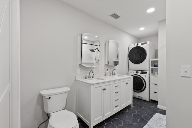 176 S Palmers Chapel Rd, White House, TN 37188 - full bath featuring estacked washer and dryer, double vanity, toilet, recessed lighting, and tile patterned flooring