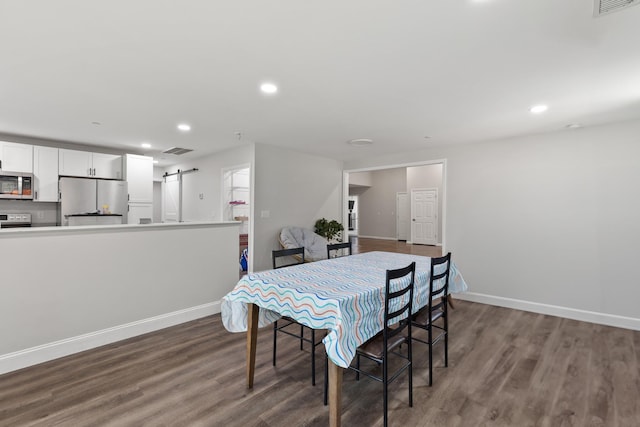 176 S Palmers Chapel Rd, White House, TN 37188 - dining space with a barn door, wood finished floors, baseboards, and recessed lighting