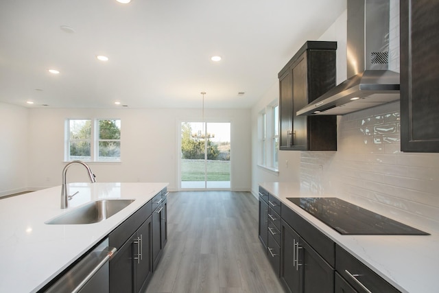 106 W Cassa Way, Mount Juliet, TN 37122 - kitchen with wall chimney range hood, a sink, black electric stovetop, backsplash, and light wood-style floors