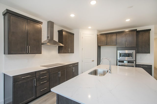 106 W Cassa Way, Mount Juliet, TN 37122 - kitchen featuring wall chimney range hood, a sink, stainless steel appliances, light wood finished floors, and light stone countertops