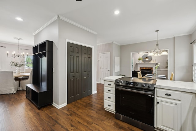 2723 Nottingham Ct, Thompsons Station, TN 37179 - kitchen featuring stainless steel electric range, a chandelier, dark wood-style flooring, a brick fireplace, and crown molding