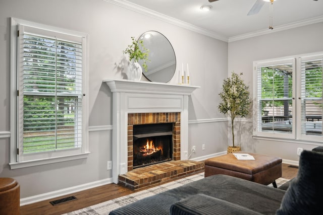 2723 Nottingham Ct, Thompsons Station, TN 37179 - living area with wood finished floors, a ceiling fan, crown molding, a brick fireplace, and baseboards