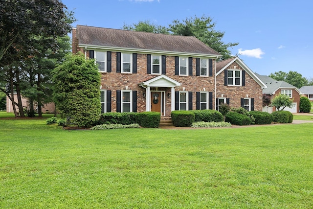 2723 Nottingham Ct, Thompsons Station, TN 37179 - colonial house with brick siding, a front yard, and roof with shingles