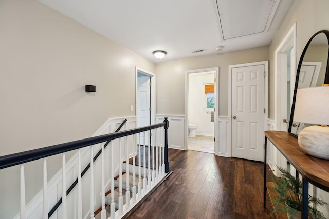2723 Nottingham Ct, Thompsons Station, TN 37179 - corridor with dark wood-type flooring, attic access, an upstairs landing, and wainscoting