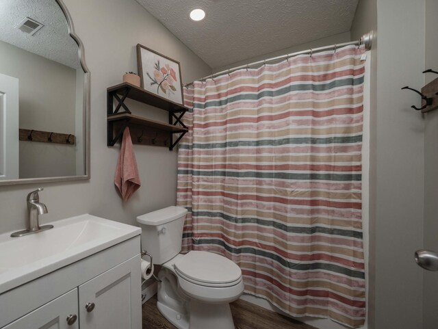 1711 Bridget Dr, Murfreesboro, TN 37129 - full bathroom featuring a textured ceiling, vanity, wood finished floors, and a shower with shower curtain