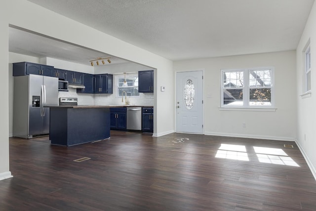 1313 W 46th St, Chattanooga, TN 37409 - kitchen with stainless steel appliances, blue cabinetry, under cabinet range hood, and plenty of natural light