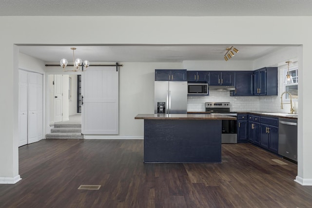 1313 W 46th St, Chattanooga, TN 37409 - kitchen featuring stainless steel appliances, blue cabinets, a sink, dark wood-type flooring, and backsplash