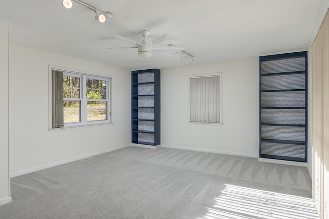 1313 W 46th St, Chattanooga, TN 37409 - carpeted spare room with track lighting, ceiling fan, baseboards, and a textured ceiling