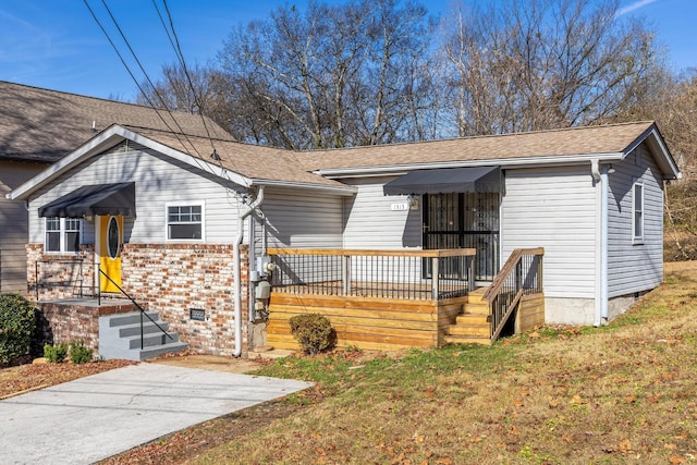 1313 W 46th St, Chattanooga, TN 37409 - view of front of home featuring a front lawn, a shingled roof, and brick siding