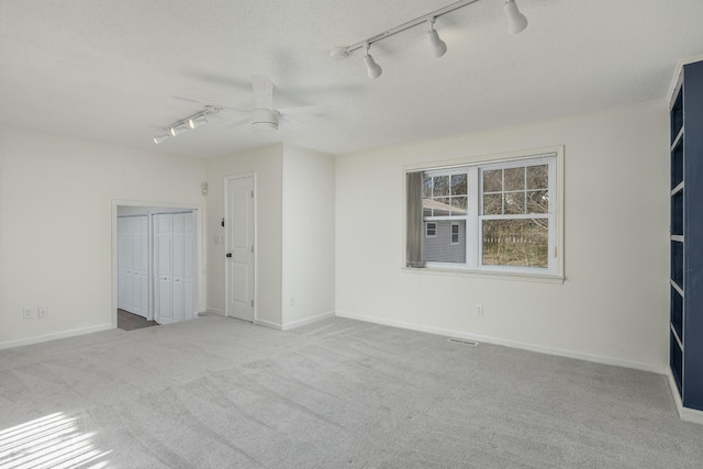 1313 W 46th St, Chattanooga, TN 37409 - unfurnished room with rail lighting, ceiling fan, carpet flooring, and baseboards