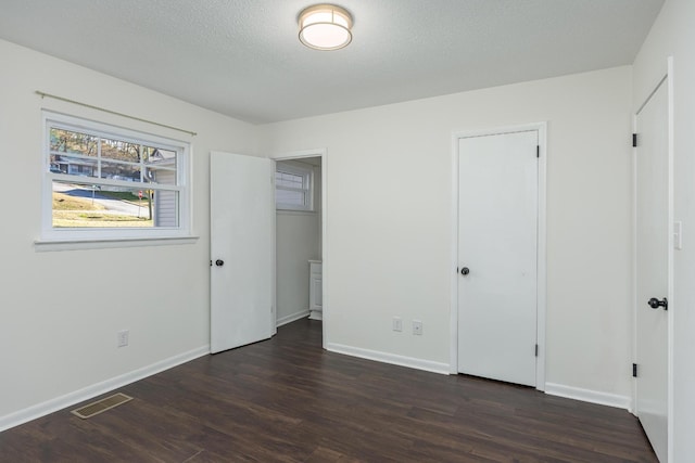 1313 W 46th St, Chattanooga, TN 37409 - unfurnished bedroom featuring dark wood-type flooring and baseboards