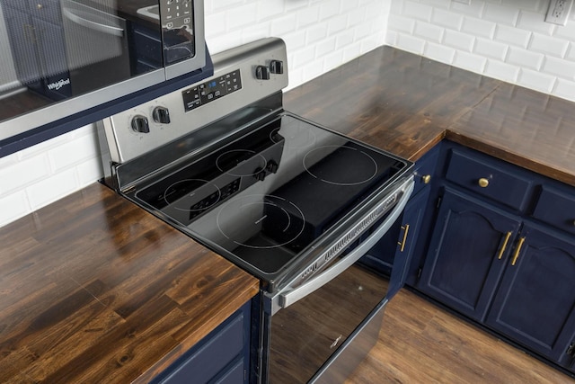 1313 W 46th St, Chattanooga, TN 37409 - kitchen featuring stainless steel appliances, blue cabinets, dark wood-type flooring, and wooden counters
