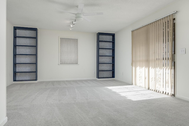 1313 W 46th St, Chattanooga, TN 37409 - unfurnished living room with carpet floors, ceiling fan, baseboards, and track lighting