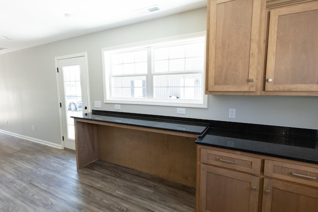130 Mazie Dr, Lafayette, TN 37083 - kitchen featuring dark wood-type flooring, dark countertops, brown cabinets, and baseboards
