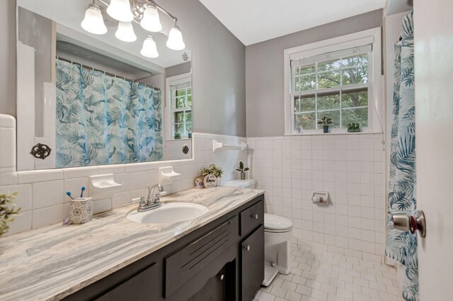 1203 Kingston Springs Rd, Kingston Springs, TN 37082 - full bath with vanity, tile patterned floors, toilet, healthy amount of natural light, and tile walls