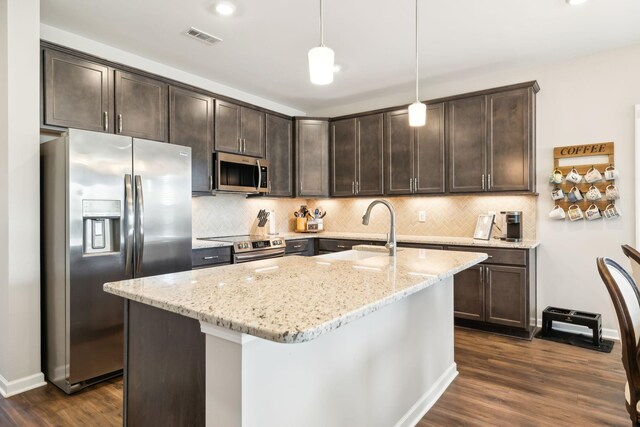 4913 Turquoise Ln, Murfreesboro, TN 37129 - kitchen featuring stainless steel appliances, dark brown cabinets, light stone counters, dark wood-type flooring, and recessed lighting