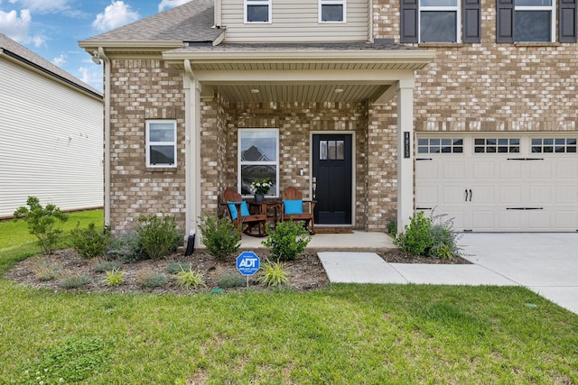 4913 Turquoise Ln, Murfreesboro, TN 37129 - view of exterior entry featuring covered porch, brick siding, a garage, and a yard