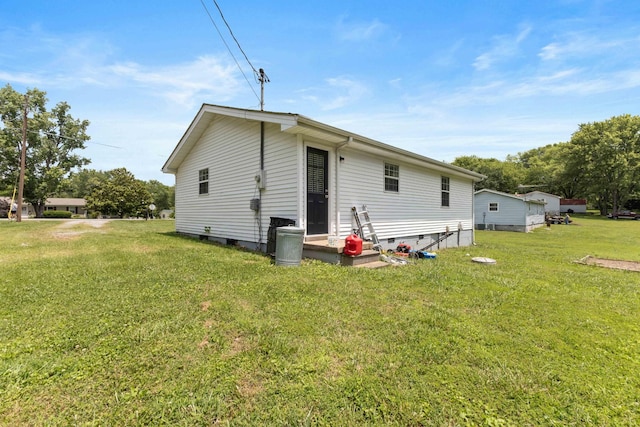 1040 Rebecca Dr, Burns, TN 37029 - back of property with a yard and crawl space