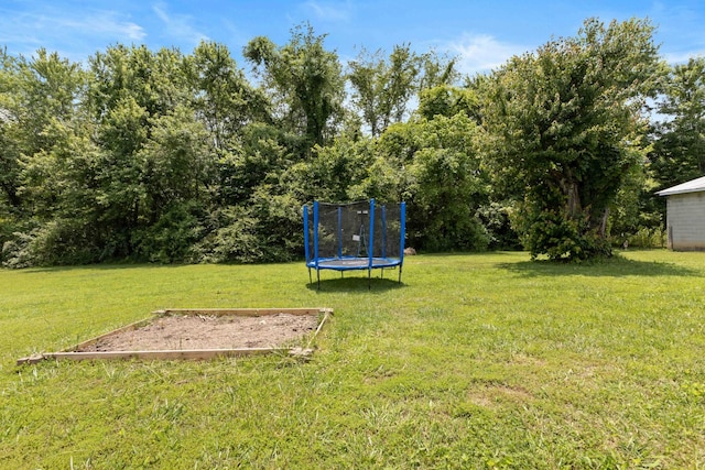 1040 Rebecca Dr, Burns, TN 37029 - view of green lawn with a trampoline