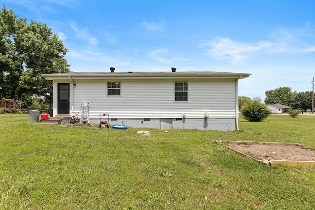 1040 Rebecca Dr, Burns, TN 37029 - rear view of property featuring crawl space, a lawn, and entry steps